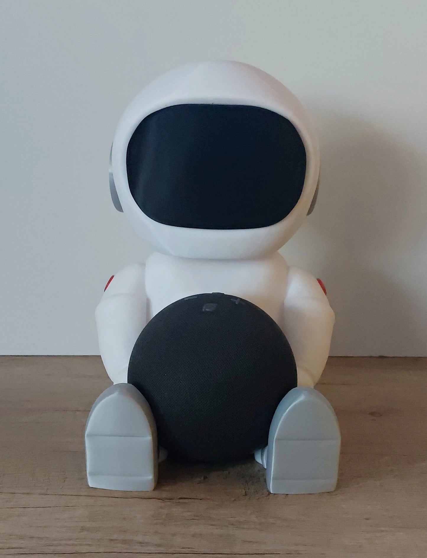 3D printed robot figure holding a black sphere, on wooden surface, megahobby 3D creations