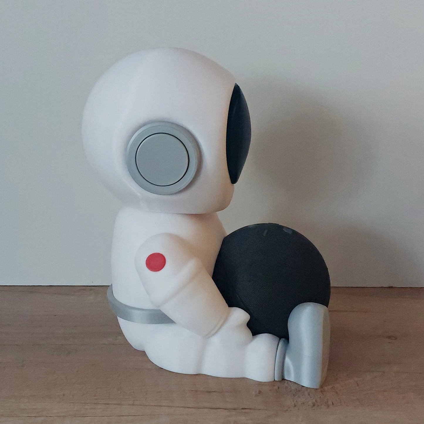 3D-printed astronaut figure sitting on wood floor holding black sphere, megahobby3dcreations decor