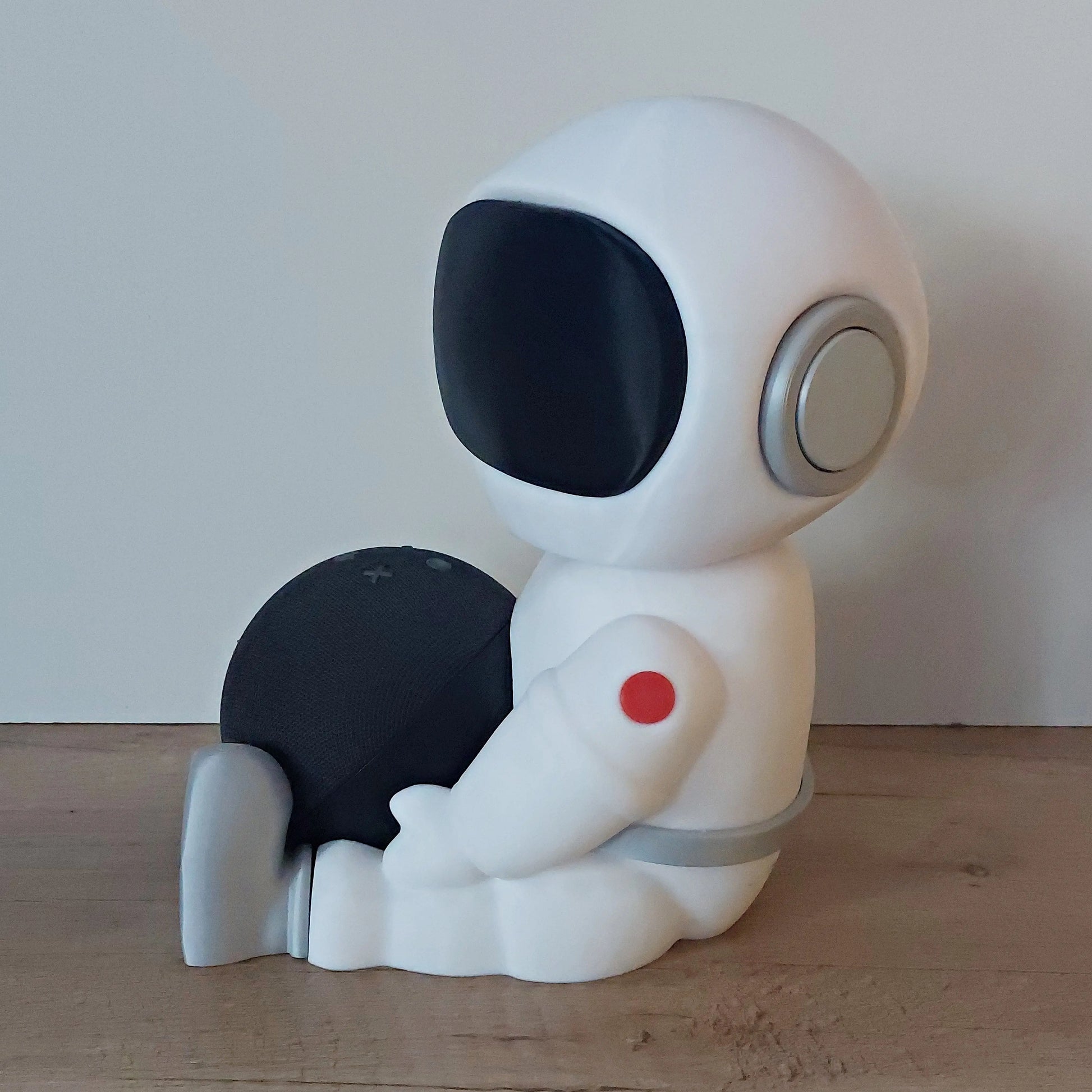 3D-printed astronaut figure holder for smart speaker, megahobby3dcreations, on wood surface