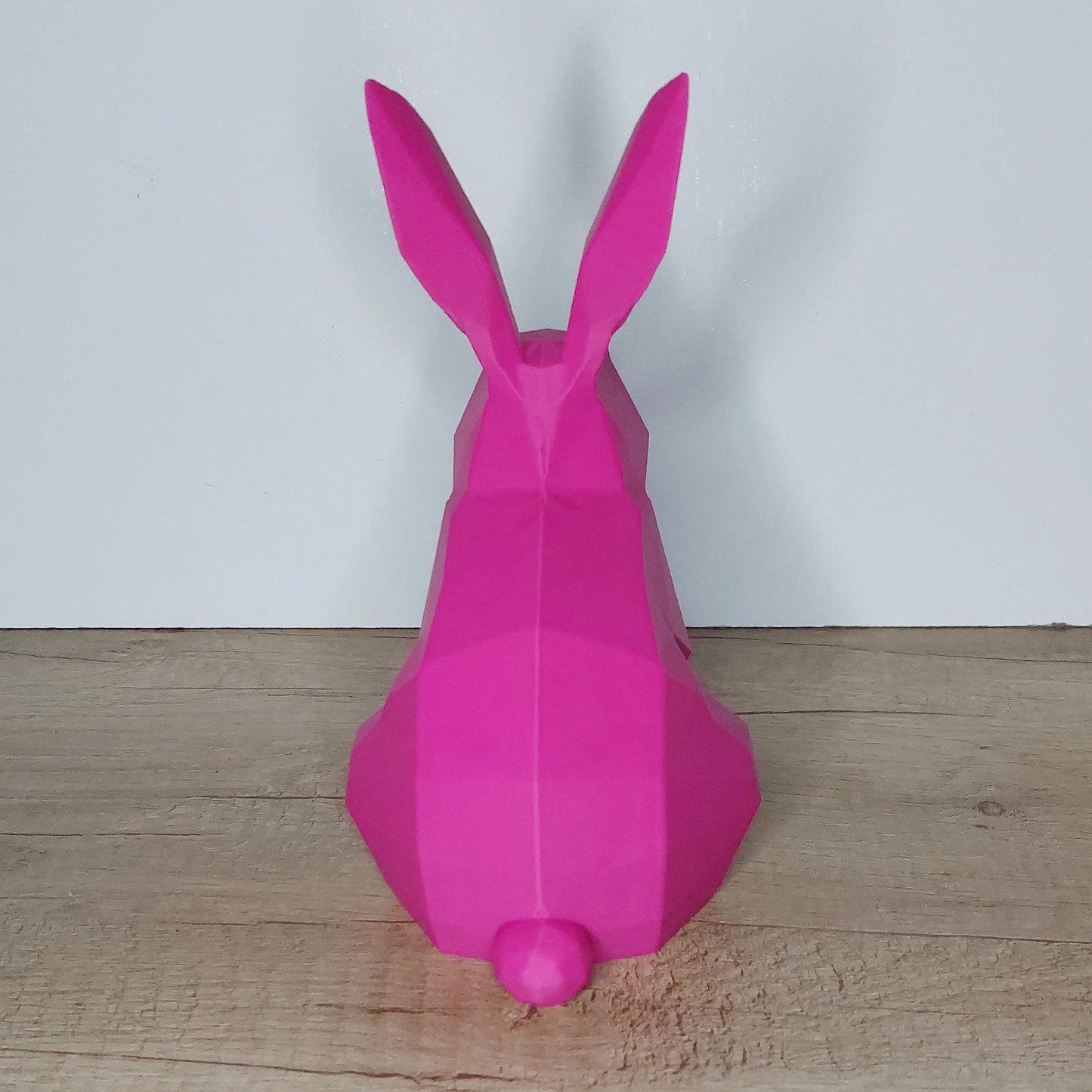 Pink low-poly 3D printed rabbit figurine on wooden surface, megahobby3dcreations product