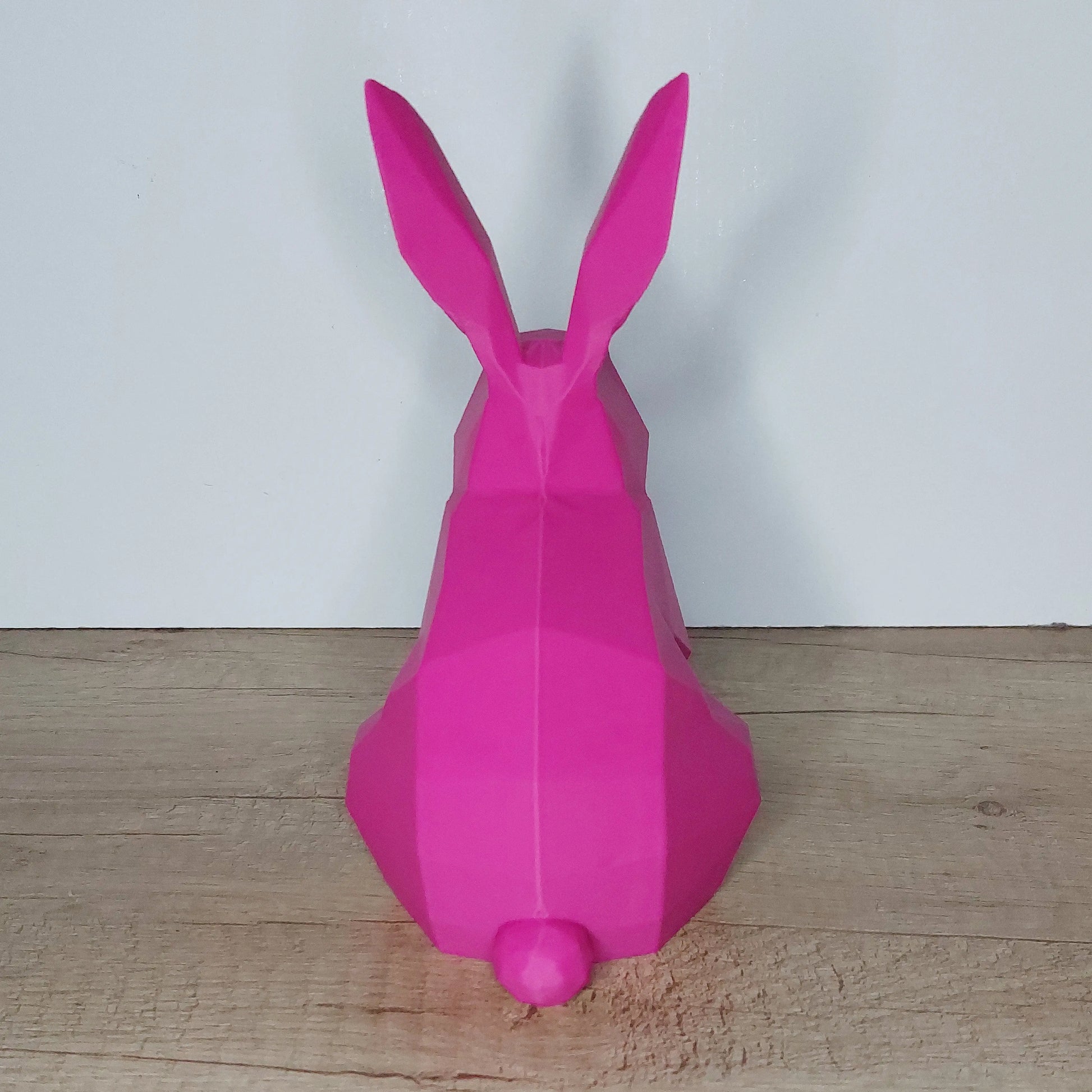 Pink low-poly 3D printed rabbit figurine on wooden surface, megahobby3dcreations product
