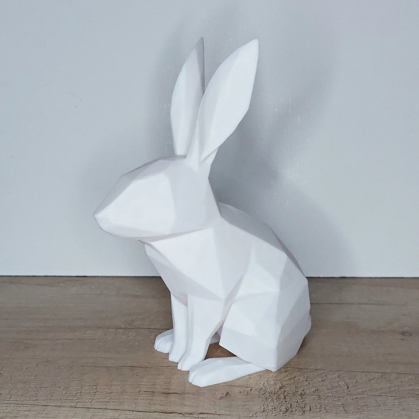 3D printed white geometric rabbit figurine on wooden surface, megahobby 3D creations decor