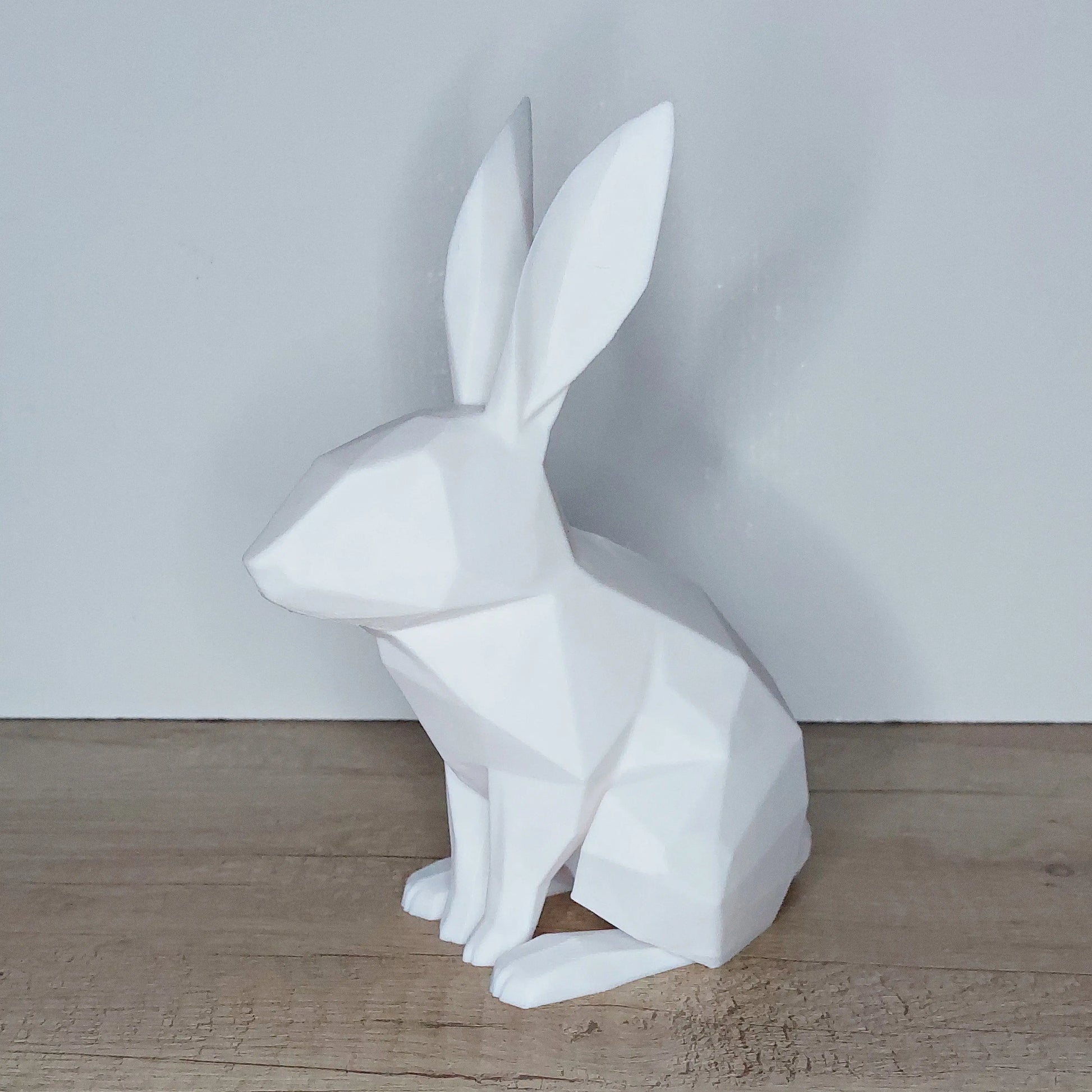 3D printed white geometric rabbit figurine on wooden surface, megahobby 3D creations decor