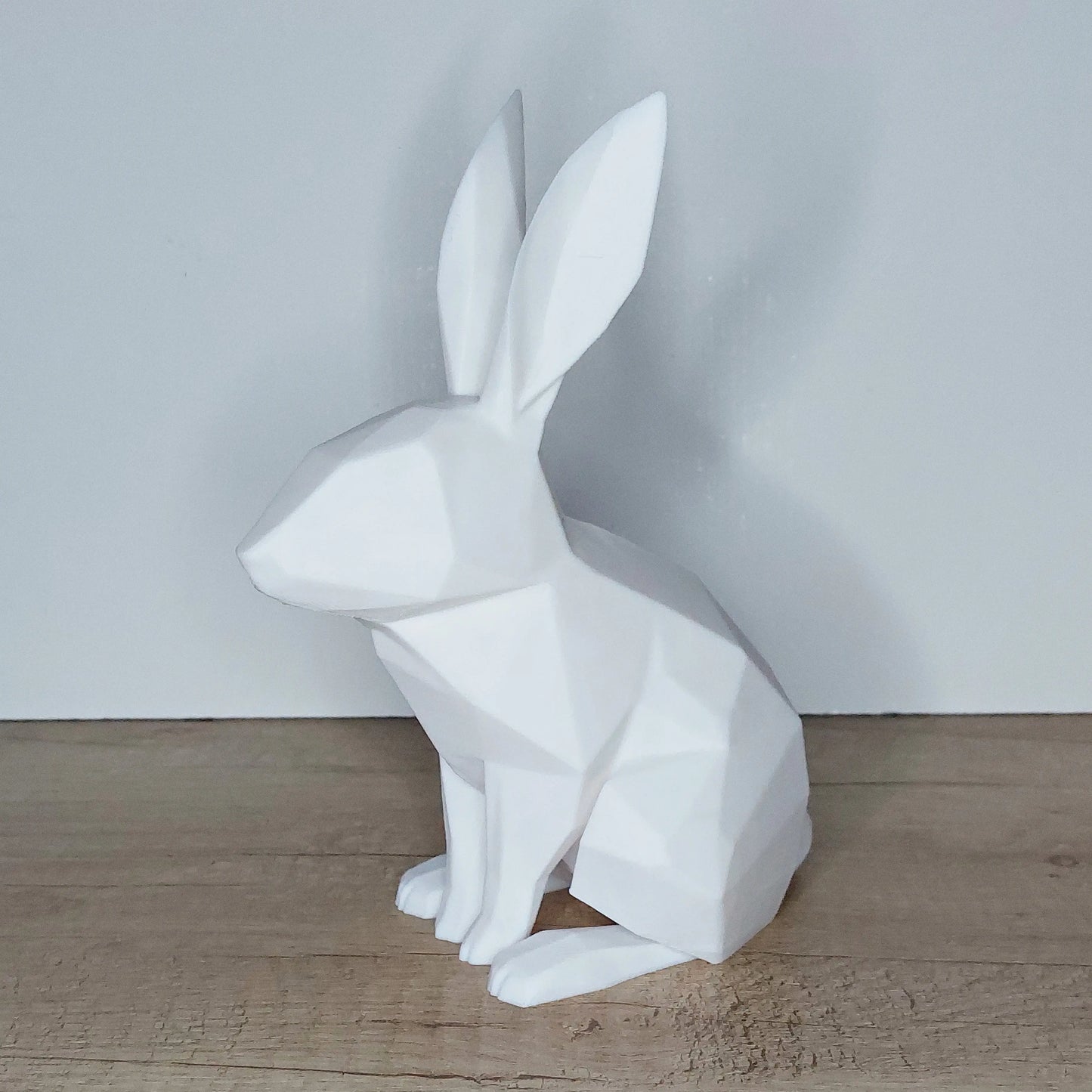 White 3D-printed geometric rabbit figurine on wooden surface, megahobby3dcreations