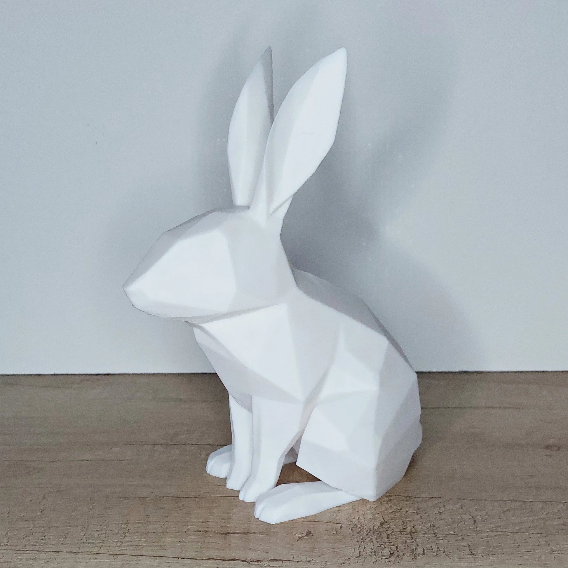 White 3D-printed geometric rabbit figurine on wooden surface, megahobby3dcreations