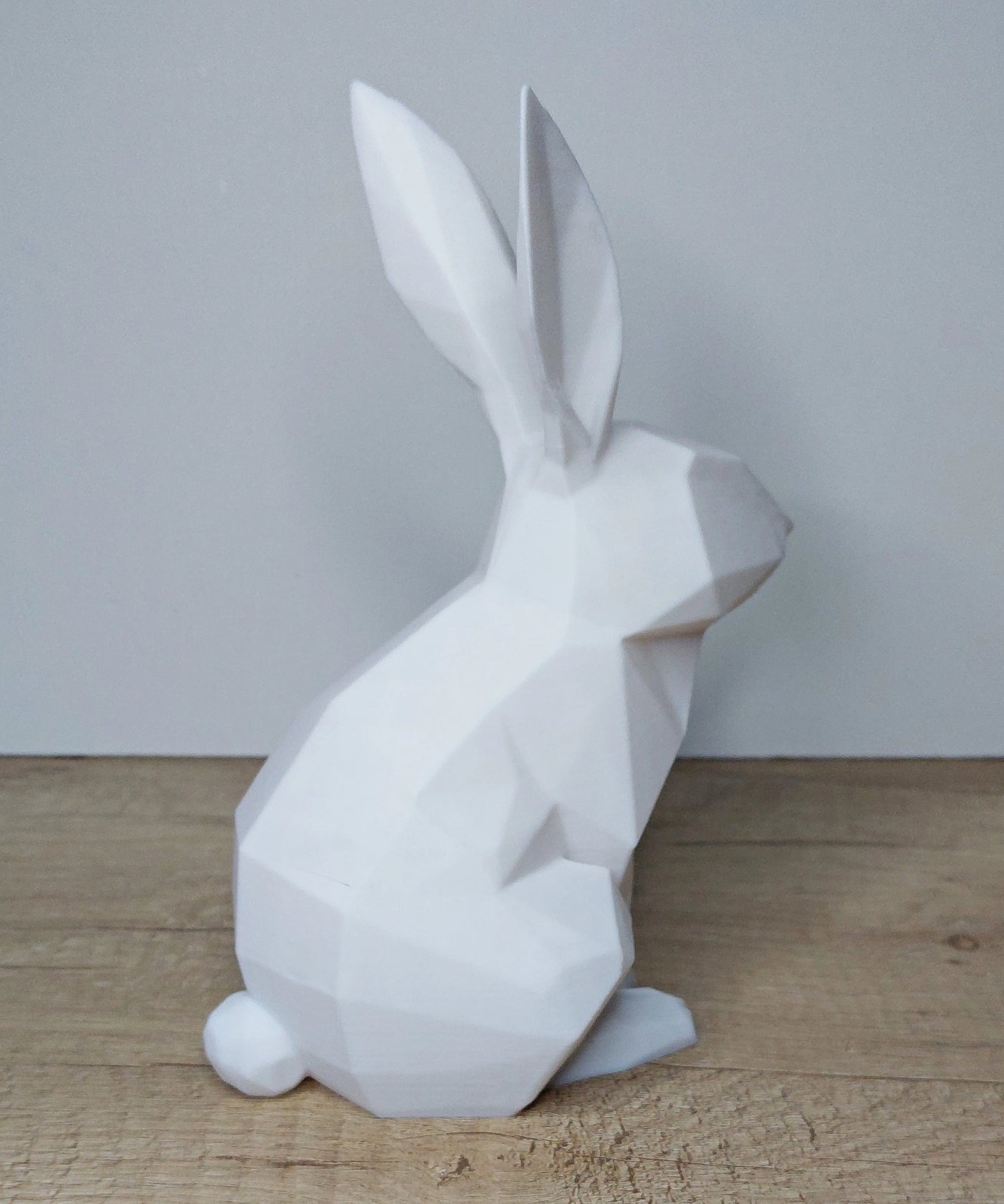 White geometric 3D printed rabbit figurine on wooden surface by megahobby3dcreations