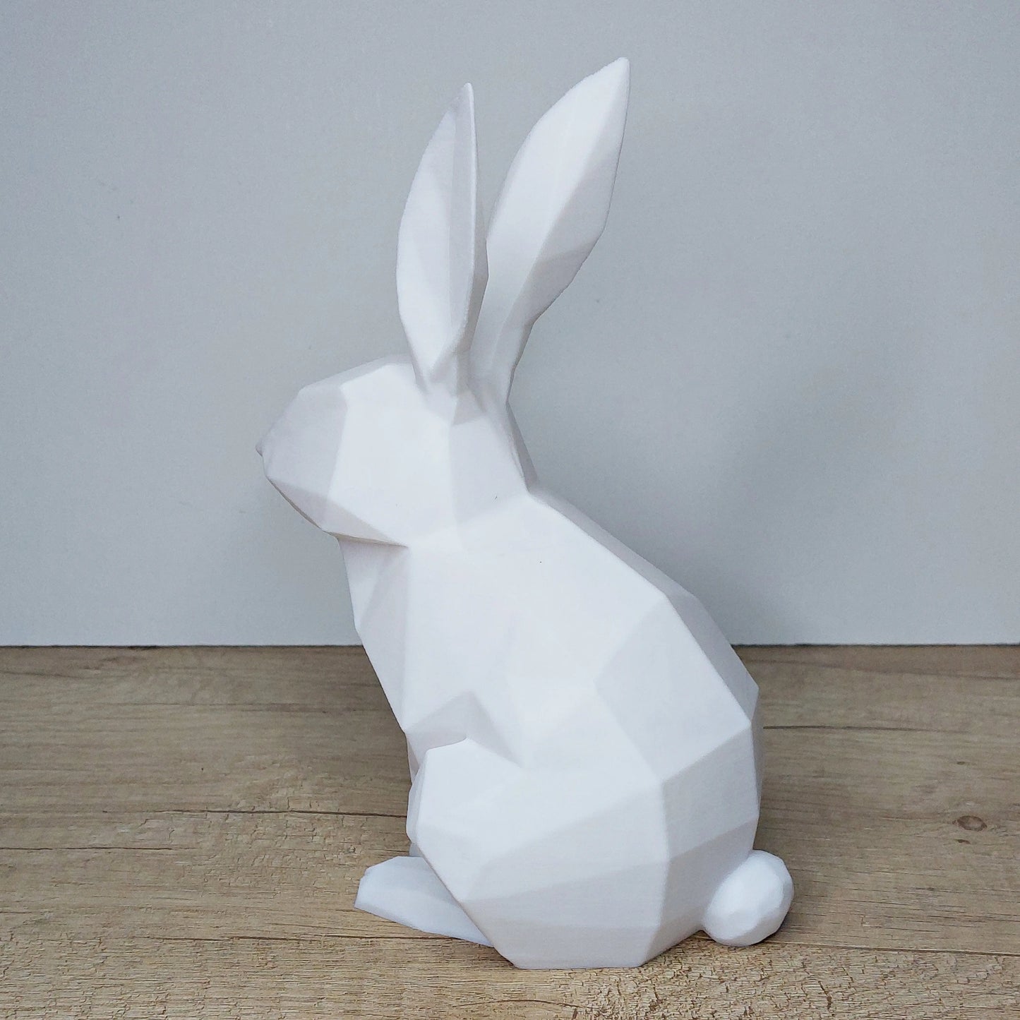 White 3D printed geometric rabbit figurine from megahobby3dcreations on wood surface