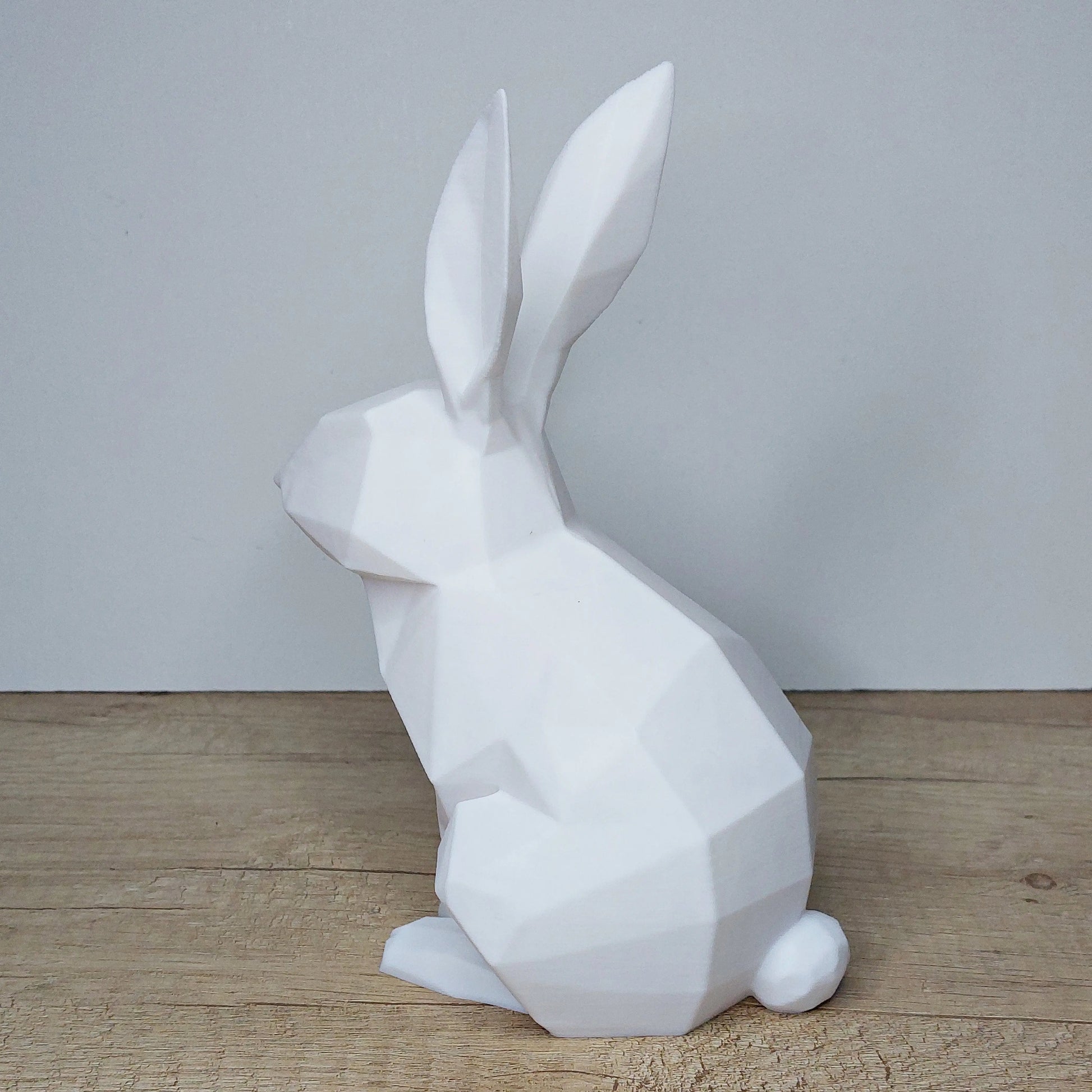 White 3D printed geometric rabbit figurine from megahobby3dcreations on wood surface
