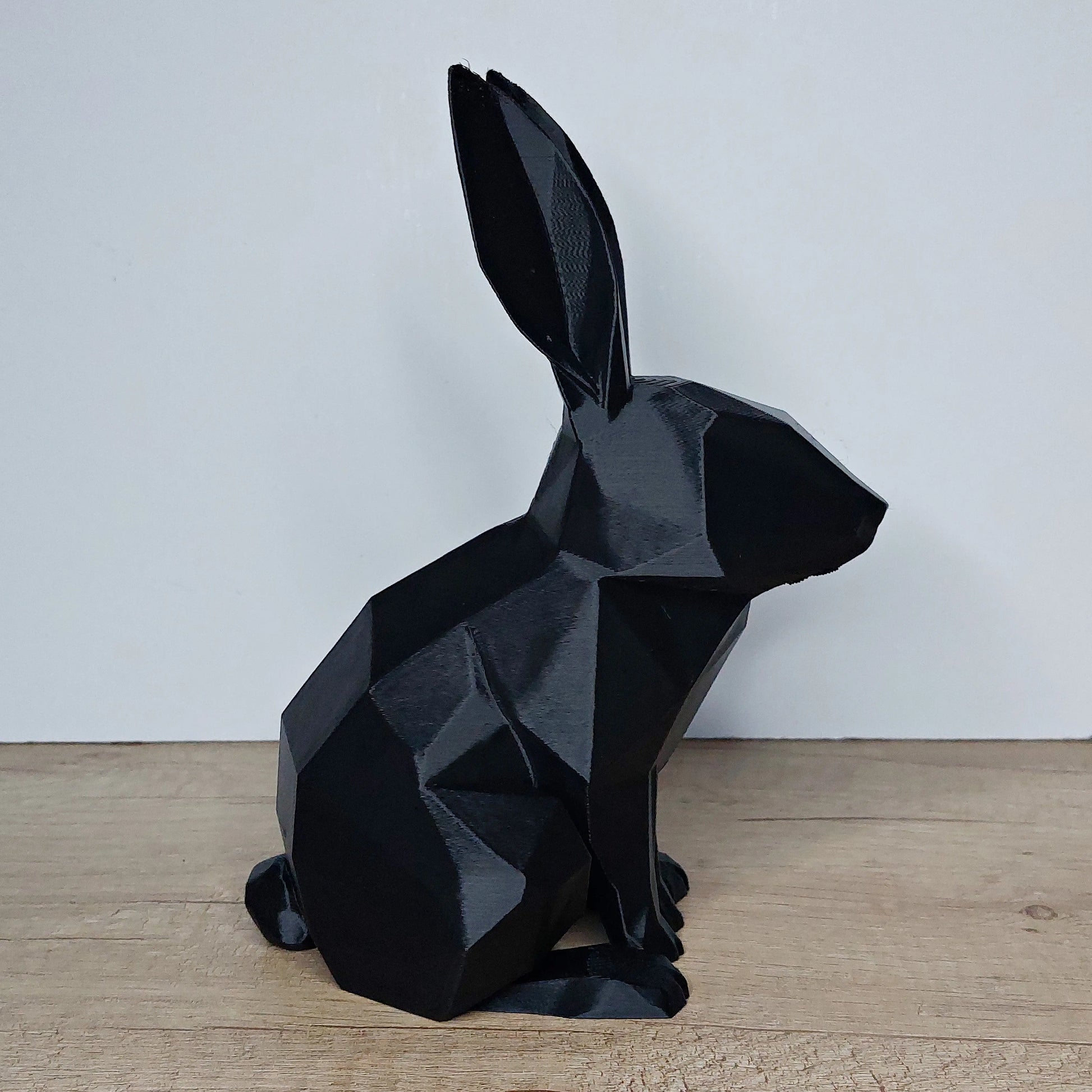 Black geometric 3D printed rabbit figurine on wooden surface, megahobby3dcreations product