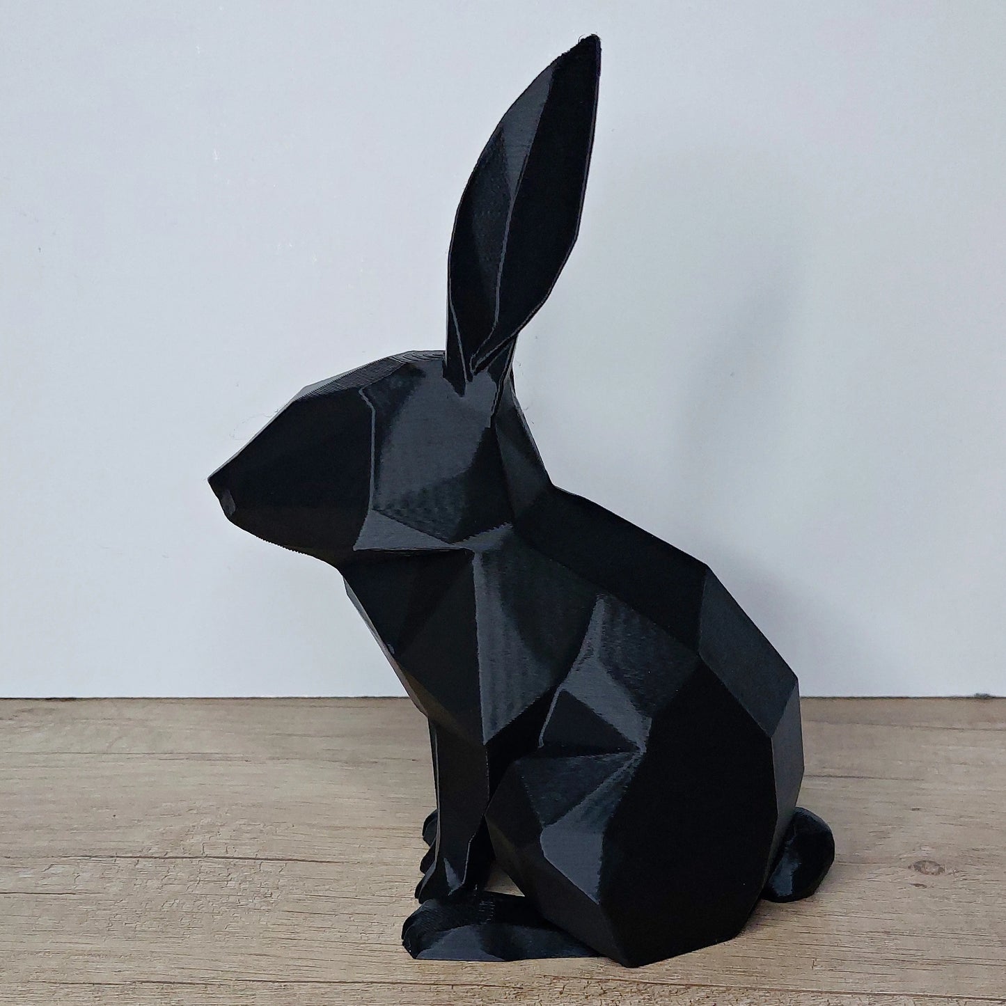 Black geometric 3D printed rabbit figurine on wooden surface, megahobby3dcreations decor