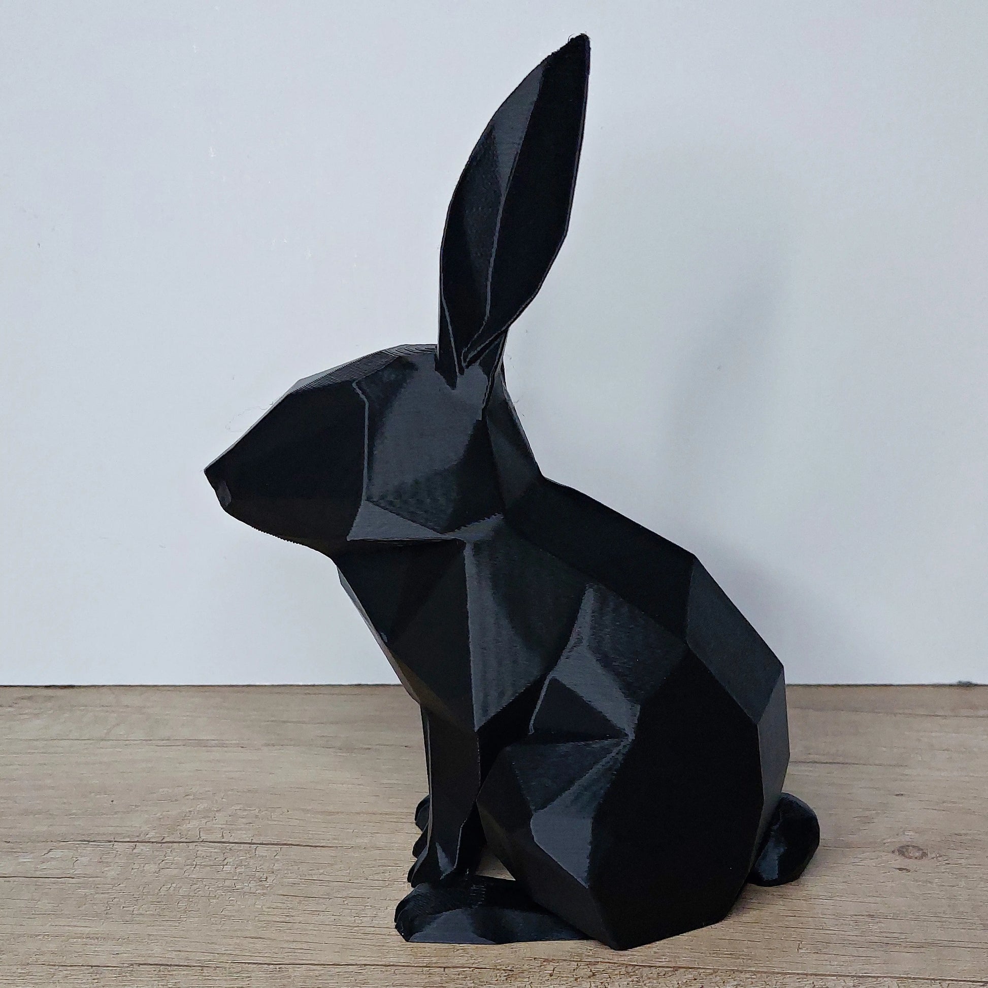 Black geometric 3D printed rabbit figurine on wooden surface, megahobby3dcreations decor